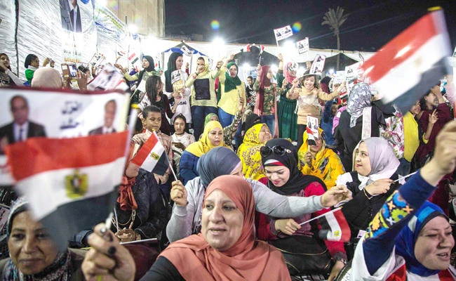 Egyptian supporters of President Abdel Fattah El-Sisi attend a rally in a neighborhood in Cairo last Friday. (AFP)