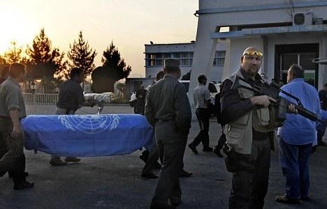 File photo of armed security guards watch over the transfer of the coffins of UN staffers killed in the attack on the Kabul guesthouse. (AP)