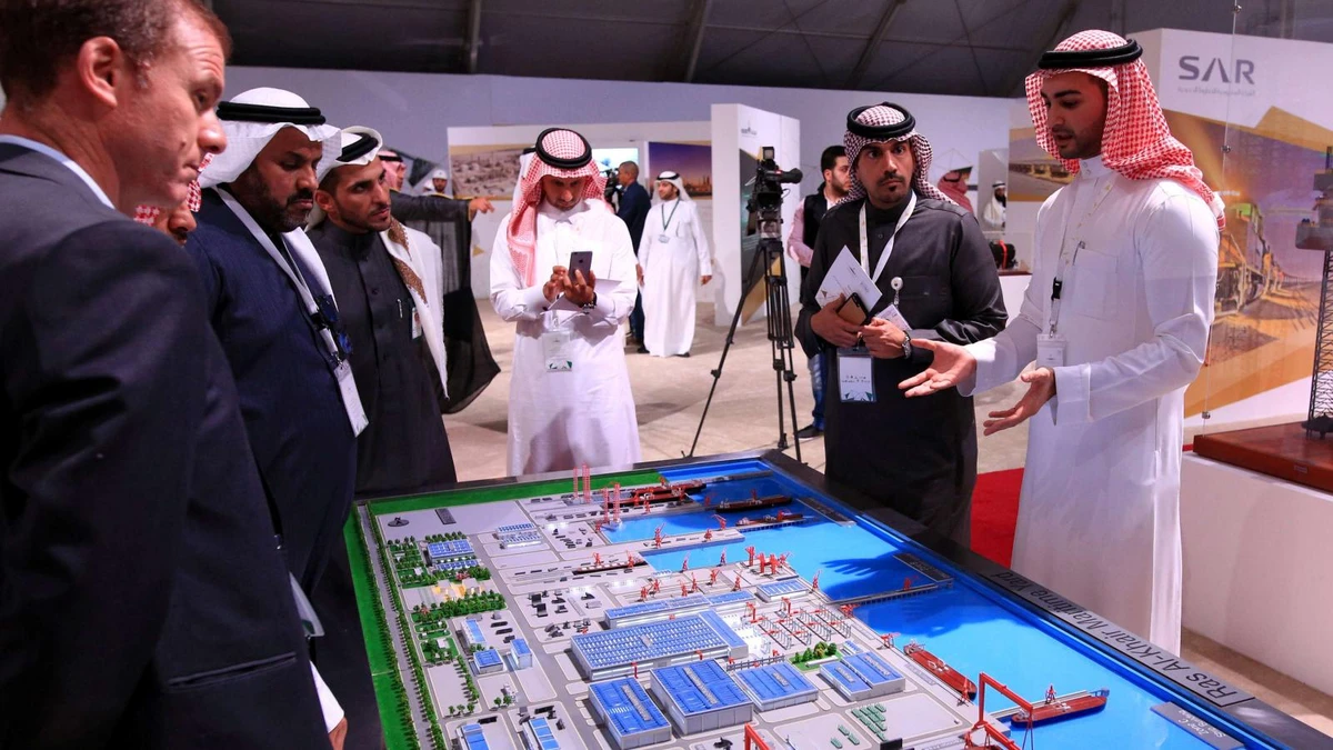 An engineer shows visitors a model of Saudi Aramco’s maritime yard in Ras al-Khair. (Reuters)