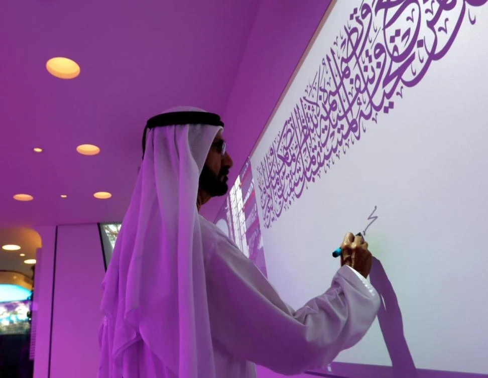 Ruler of Dubai Sheikh Mohammed bin Rashid Al-Maktoum, signs on the board during the official opening of the world's first functional 3D printed offices in Dubai. (Reuters)
