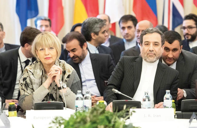Abbas Araghchi, right, political deputy at the Ministry of Foreign Affairs of Iran, and the secretary-general of the EU External Action Service (EEAS), Helga Schmid, attend E3/EU+3 and Iran talks at Palais Coburg in Vienna, Austria on Friday. (AFP)