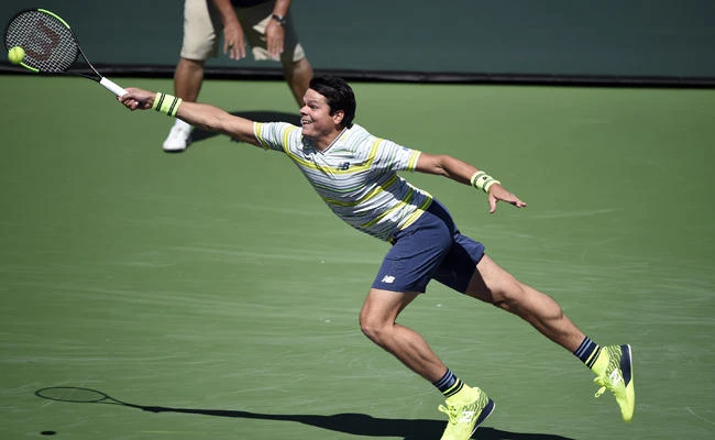 Milos Raonic of Canada stretches to return a serve by Sam Query of United States during Day 12 of BNP Paribas Open on March 16, 2018 in Indian Wells, California. (Kevork Djansezian/Getty Images/AFP)
