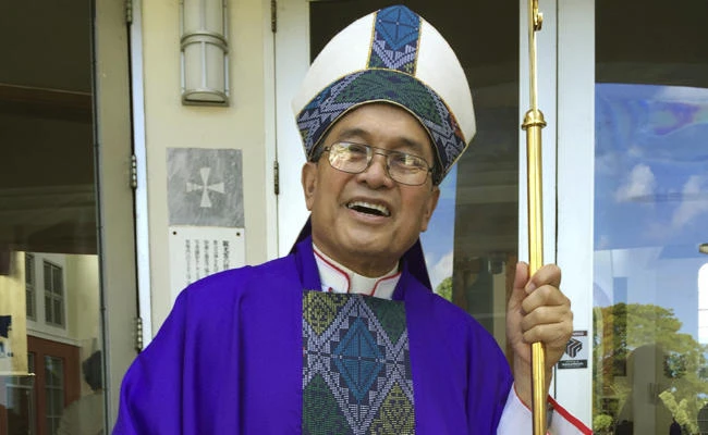 In this Nov. 2014 file photo, Archbishop Anthony Apuron stands in front of the Dulce Nombre de Maria Cathedral Basilica in Hagatna, Guam. (AP Photo/Grace Garces Bordallo, File)