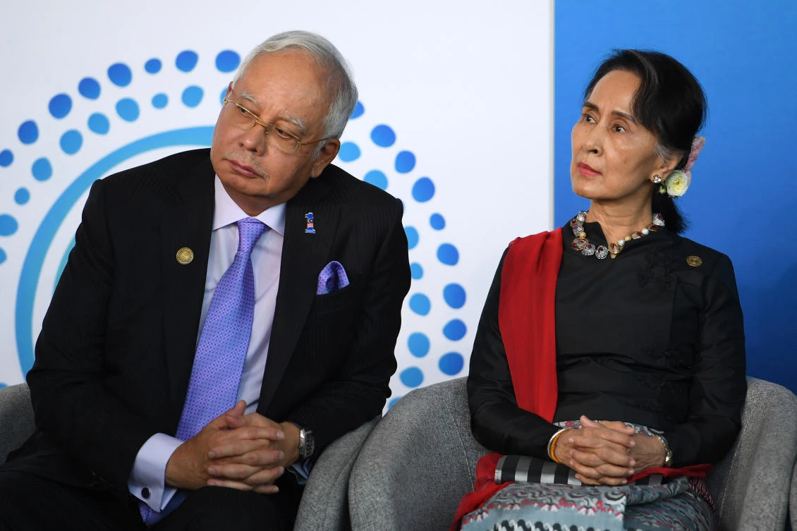 Malaysian Prime Minister Najib Razak (L) and Myanmar State Counsellor Aung San Suu Kyi (R) listen to an address as they attend the New Colombo Plan Reception at the ASEAN (Association of Southeast Asian Nations)-Australia special summit being held in Sydney on March 17, 2018. (Dan Himbrechts/POOL/AFP)