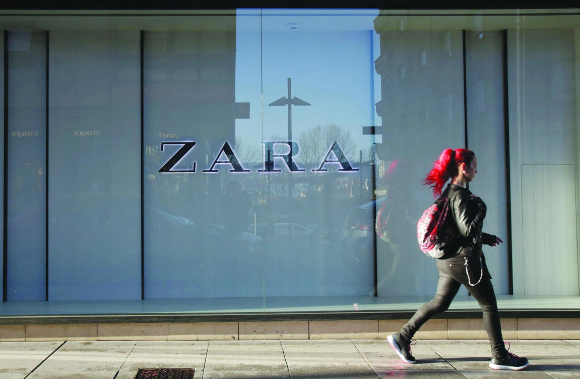A woman walks past the window of a store of Inditex’s main brand Zara in Pontevedra, Spain. (Reuters)