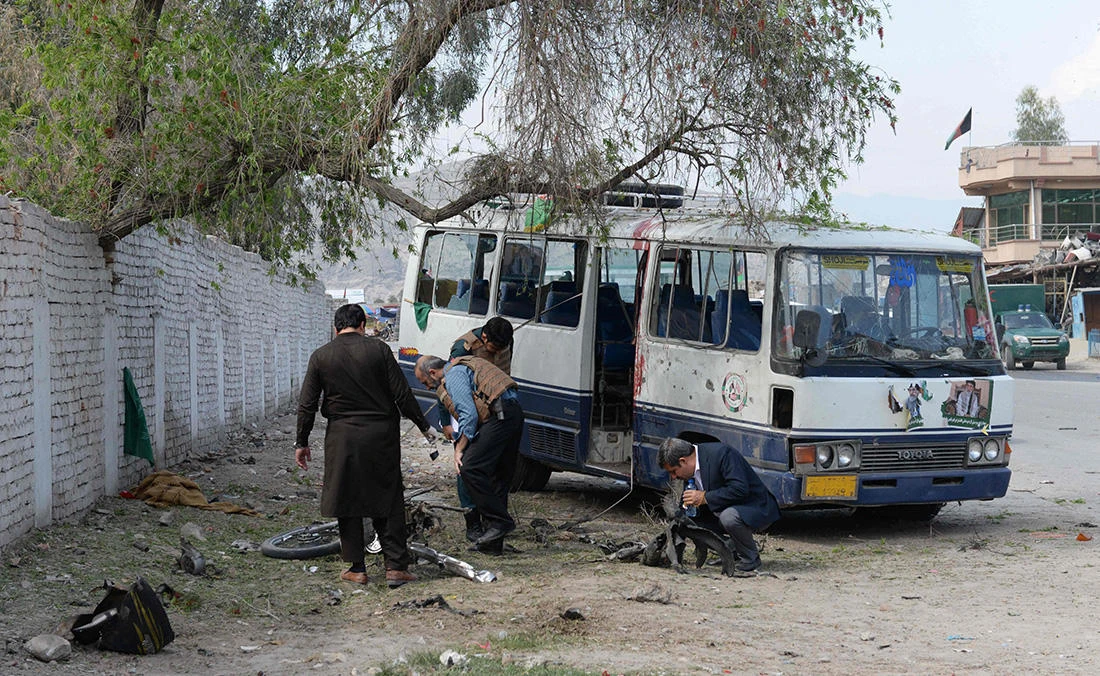 Afghan security personnel inspects the site of bomb blast in Jalalabad on March 19, 2018. (AFP)