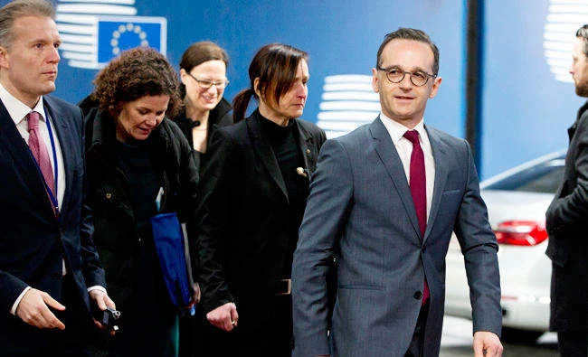 German Foreign Minister Heiko Maas, right, arrives for a round table meeting of EU foreign ministers at the Europa building in Brussels on Monday. (AP)