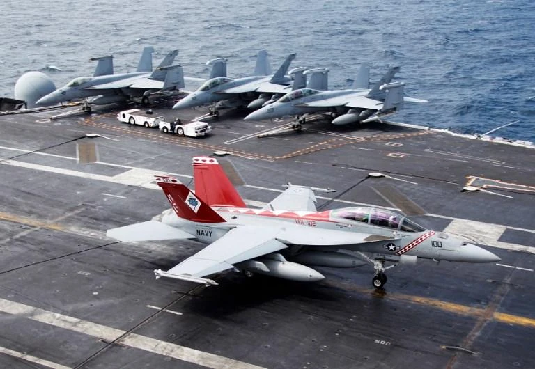 Crew members look at a US Navy F/A-18 Super Hornet fighter as it lands on the deck of the aircraft carrier USS George Washington during joint military drills between the US and South Korea in the Yellow Sea in this 2012 photo. (AFP)