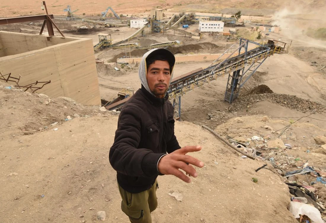 A worker gestures at a phosphate production plant in Kef Eddour, in the Metlaoui mining region, one of the main mining sites in central Tunisia, after workers restarted production after a month-long strike, on March 8, 2018. (AFP)