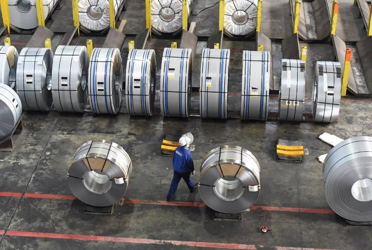 A worker packs coils for delivery at the production site of German steel technology group Salzgitter in Salzgitter, Germany. US President Donald Trump has ordered border taxes of 25 percent on steel imports and 10 percent on aluminum, provoking promises of retaliation from partners like the European Union. (AFP)