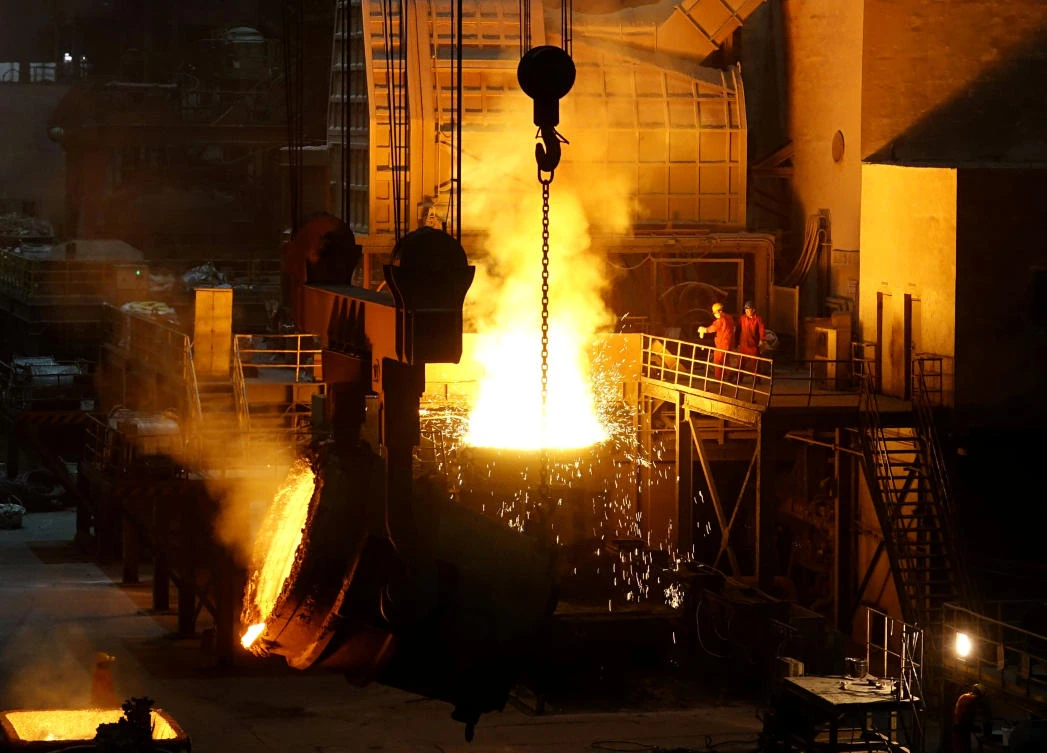 Above, workers at a steel mill of Dongbei Special Steel in Dalian, Liaoning province. US President Donald Trump earlier announced hefty tariffs on steel and aluminum imports, aimed at hitting Chinese overproduction. (Reuters)