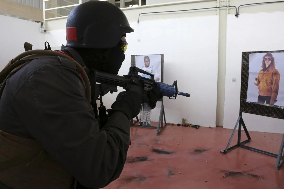 In this Sunday, March 18, 2018 photo, a member of a Tunisian police commando unit takes part in a practice raid of a hideout at the Jordan Gendarmerie Training Academy, in al-Swaqa, about 44 miles (70 km) south of Amman, Jordan. (AP)