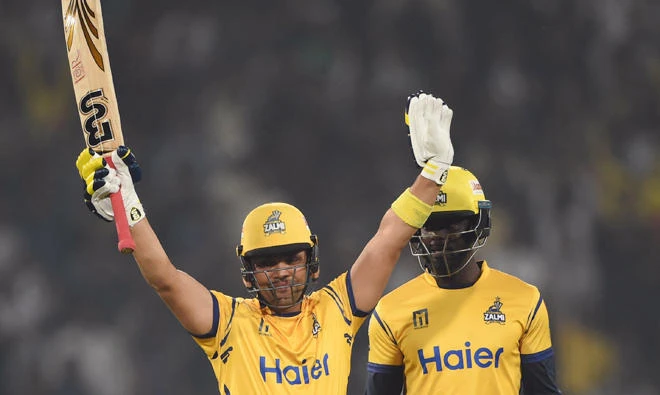 Kamran Akmal (L) of Peshawar Zalmi celebrates after he scored a half century against Karachi King next to his teammate Andre Fletcher during the Twenty20 (T20) cricket match of the Pakistan Super League (PSL) at The Gaddafi Cricket Stadium in Lahore on Mar. 21, 2018. (AFP)