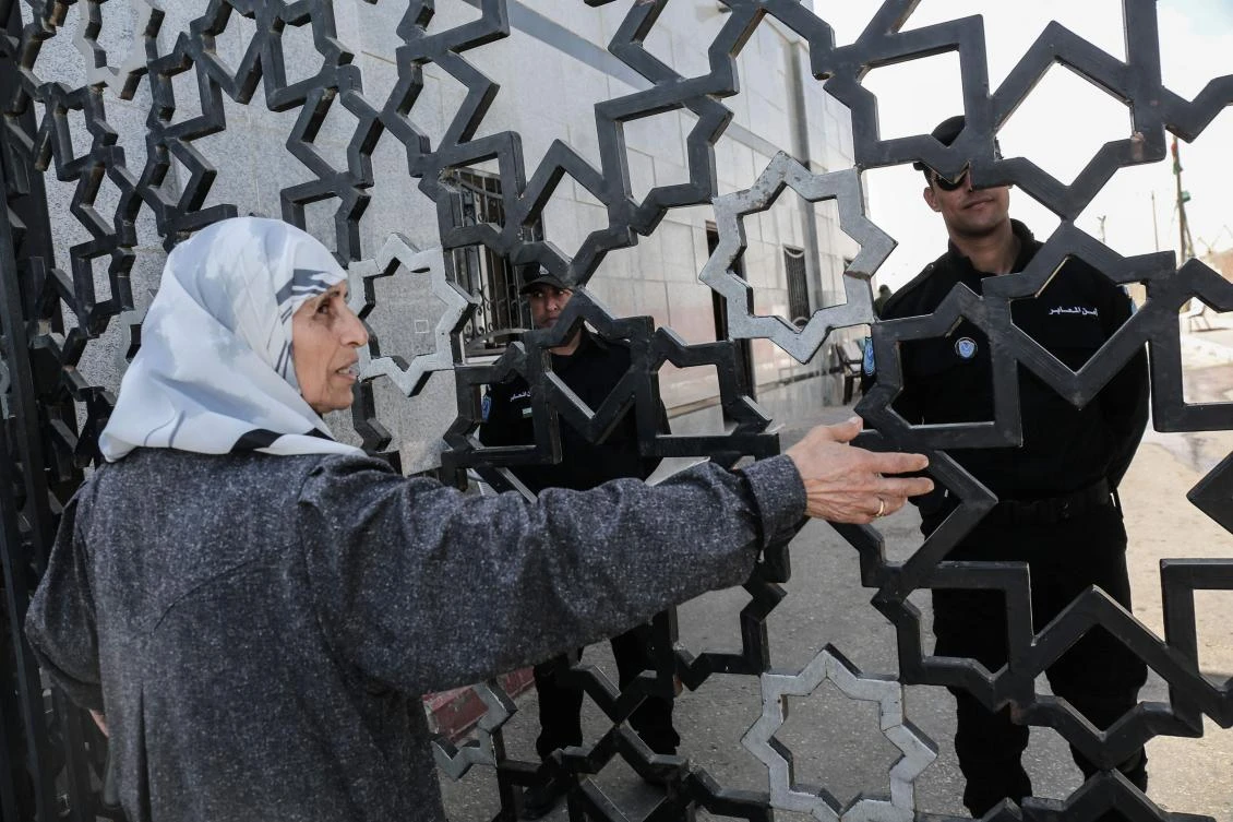 A Palestinian woman takes part in a protest calling for the Egyptian authorities to open the Rafah Border Crossing in the southern Gaza Strip on March 22, 2018. (AFP)