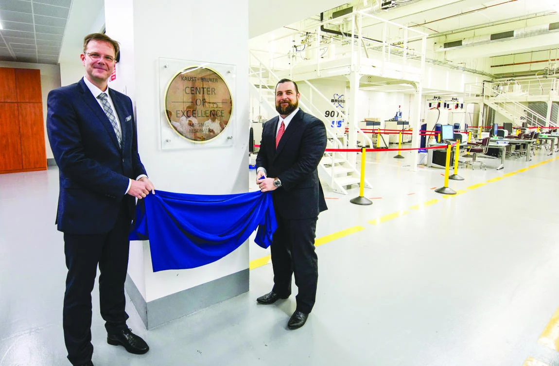 Justin L. Mynar, executive director of the KAUST Core Labs, right, and Andreas Kamlowski, president of services and lifecycle support Bruker bio spin, unveil the KAUST-Bruker Center of Excellence in Magnetic Resonance.