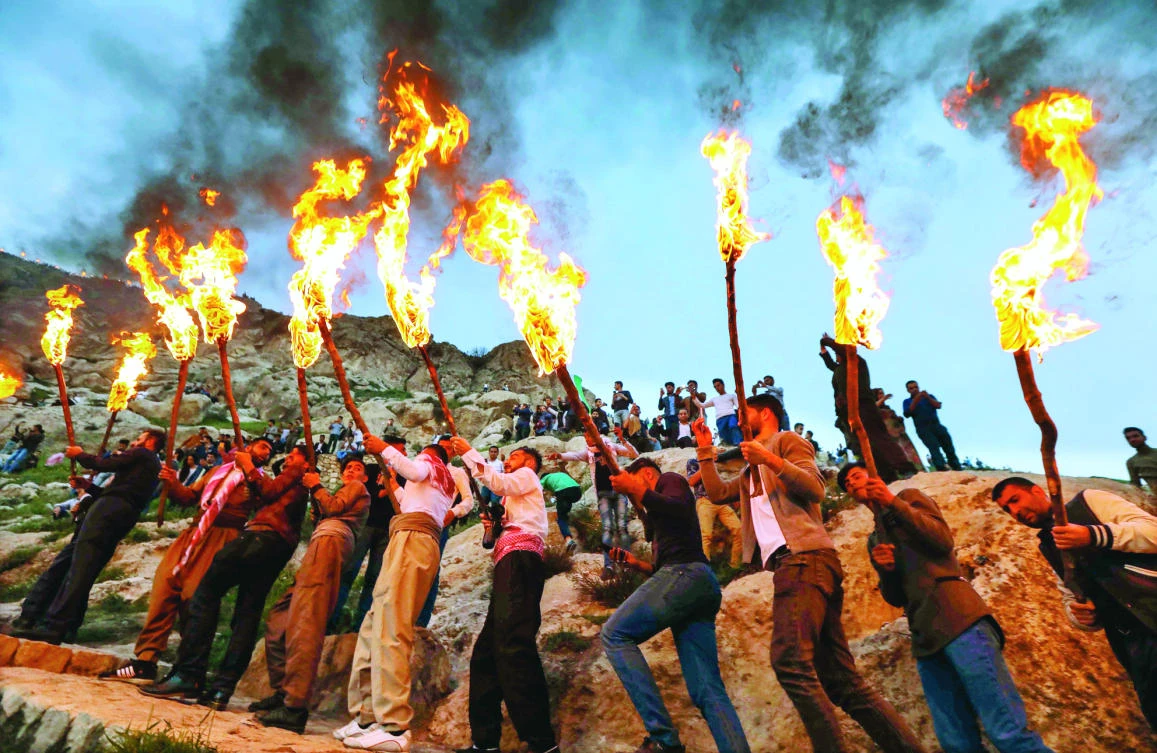 Iraqi Kurds holding lit torches walk up a mountain in the town of Akra, 500 kilometers north of Baghdad, during recent Nowruz (new year) celebrations. (AFP)