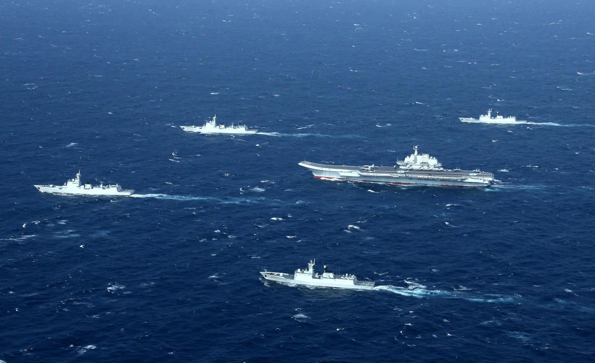 This aerial photo shows a Chinese navy formation, including the aircraft carrier Liaoning (C), during military drills in the South China Sea. (AFP)
