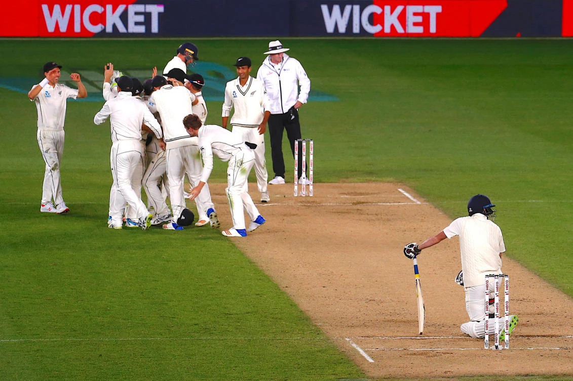 New Zealand's Trent Boult celebrates with team mates as England's James Anderson kneels on the pitch after New Zealand won the match on the fifth day of the first Test match. (REUTERS)