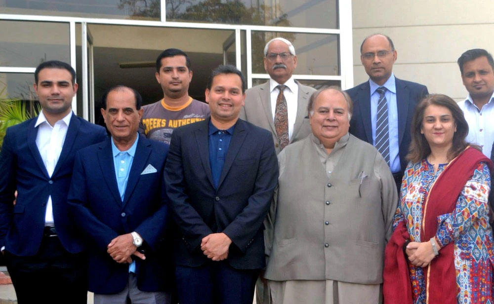 Sanjeevan Balasingam, FIFA’s regional director for Asia and Oceania, with Sardar Naveed Haider Khan, vice president of the PFF, Ahmed Yar Khan Lodhi, general secretary, and PFF staff at its headquarters in Lahore. (Photo courtesy: Pakistan Football Federation)