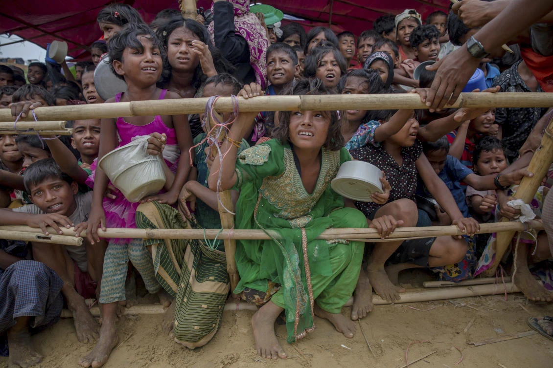 Rohingya Muslim children wait for food handouts distributed by a Turkish aid agency at Thaingkhali refugee camp, Bangladesh. Myanmar’s government has rejected two reports presented to the UN Human Rights Council that concluded it committed extreme human rights violations, probably amounting to crimes under international law, in its repression of several minority groups. (File Photo: AP)