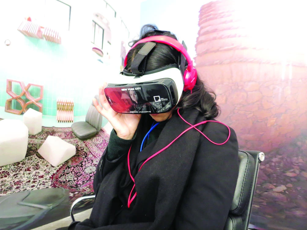 Selection of images of Mariana Souza, 25, and other New Yorkers, trying out virtual reality goggles and watching a VR movie about Saudi artists at an auction house on New York’s Park Avenue on Monday. Credit: James Reinl