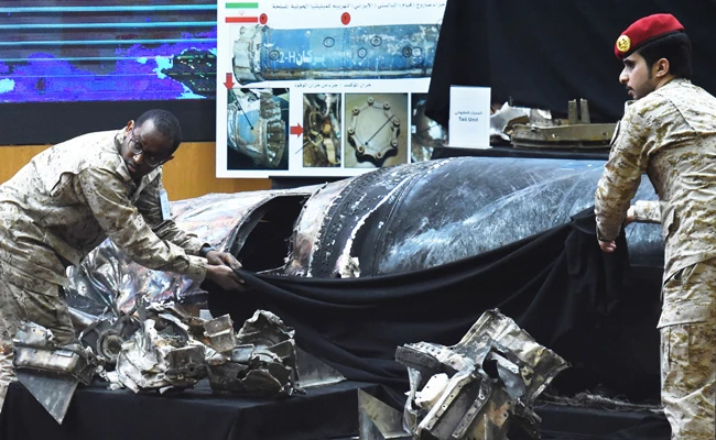 Saudi soldiers display the remains of Iranian-made Houthi ballistic missiles at a press conference in Riyadh on Monday. Seven missiles fired from Yemen and targeting cities in Saudi Arabia were intercepted by Saudi air defense forces on Sunday night. (AFP)