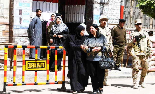 Egyptian women leave a polling station casting their votes at a polling station in the Nile Delta City of Tanta, 120 kilometres north of Cairo, on March 27, 2018 on the second day of the 2018 presidential elections. (AFP)