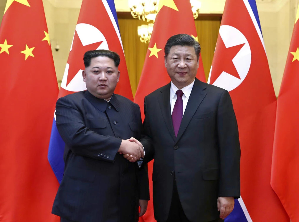 North Korean leader Kim Jong Un, left, and Chinese President Xi Jinping shake hands in Beijing, China. (AP)