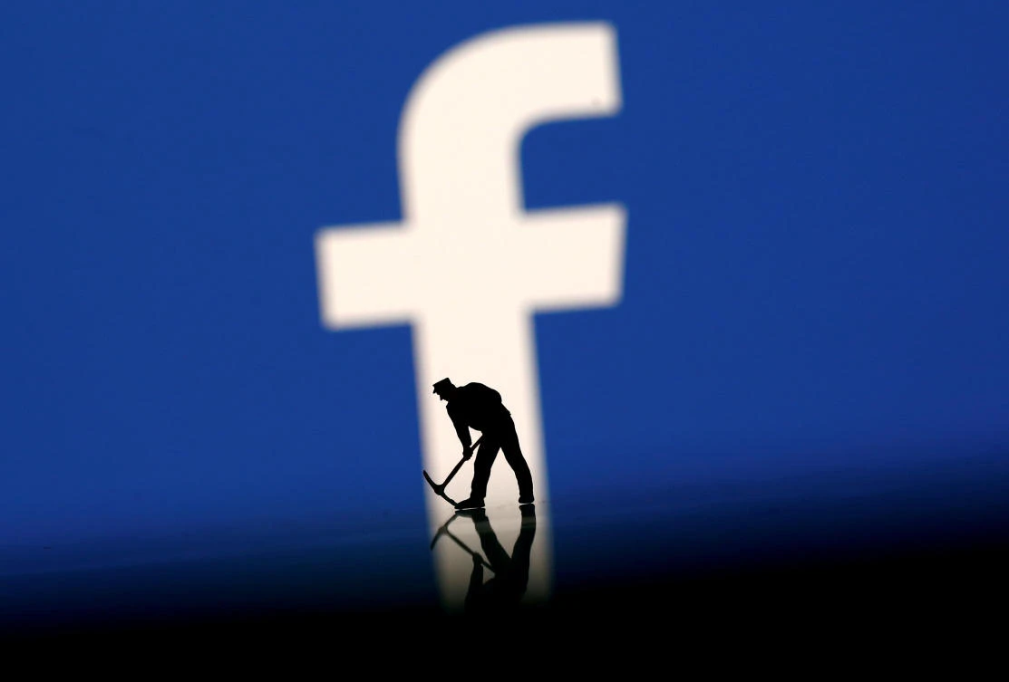 A figurine is seen in front of the Facebook logo in this illustration taken, March 20, 2018. (Reuters)