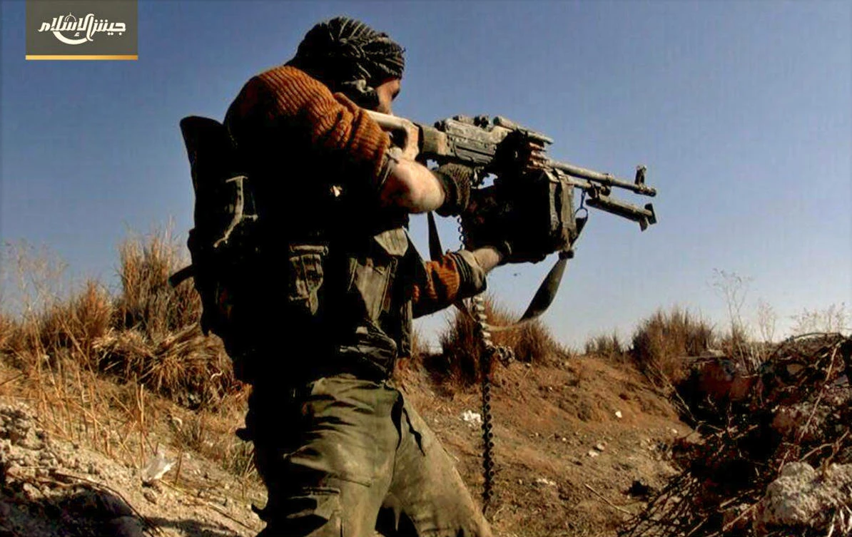 This photo provided Feb. 2, 2018, by the Syrian rebel group Army of Islam, shows a fighter with the Army of Islam rebel group, firing his weapon during clashes with government forces in Housh al-Dhawahira in the eastern Ghouta region near Damascus, Syria. (AP)