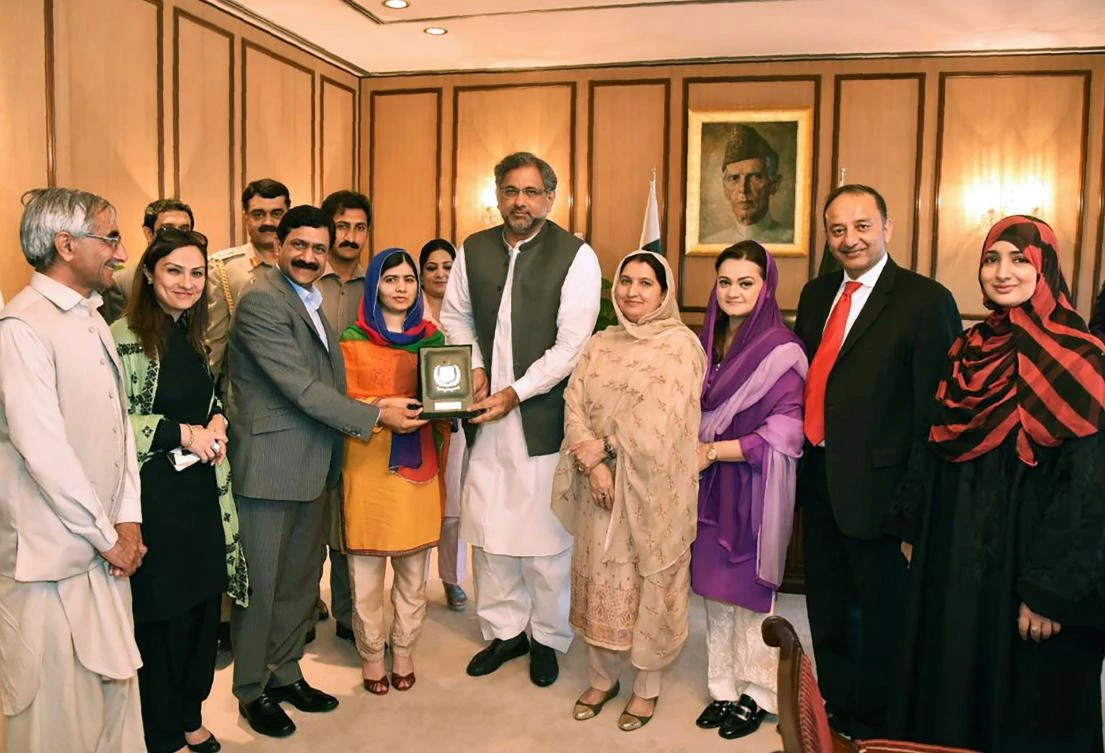 This handout photograph released by the Press Information Department (PID) on March 29, 2018, shows Pakistani Prime Minister Shahid Khaqan Abbasi (C) presenting a shield to Pakistani activist and Nobel Peace Prize laureate Malala Yousafza (4L) at the Prime Minister Office during her visit to Islamabad. Nobel peace laureate Malala returned to Pakistan on March 29, saying tearfully that it was "a dream" to come home for the first time since she was airlifted to Britain after being shot in the head by a Taliban gunman more than five years ago. (AFP)