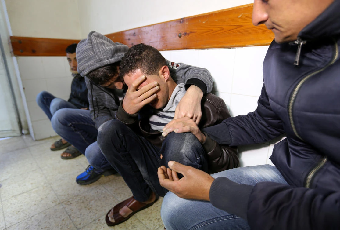Relatives of a Palestinian farmer who was killed along Israel border with Gaza, react at a hospital in the southern Gaza Strip March 30, 2018. (Reuters)