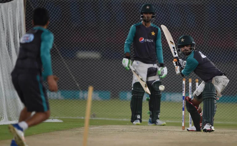 Pakistani cricketers Babar Azam, right, hits the ball as teammate Fakhar Zaman looks on during a practice session at the National Cricket Stadium in Karachi on March 29, 2018. (AFP)