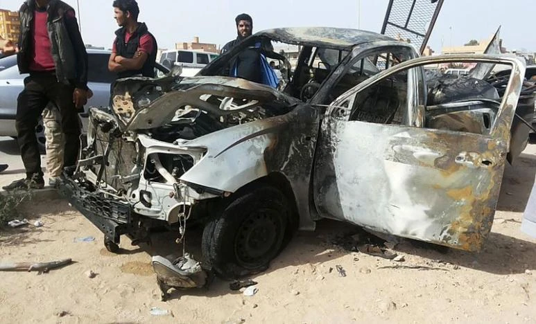 In this file photo, people stand at the scene of a car bomb explosion in Libya. (Reuters)