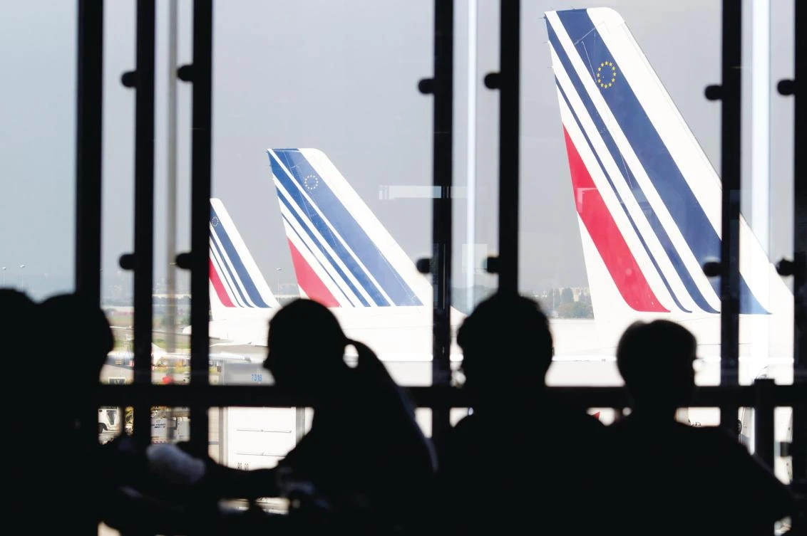 Passengers are left waiting as Air France aircraft stand idle at Paris-Orly airport. Striking pilots and ground crew forced the national carrier to cancel a quarter of its flights on Friday. (AFP)