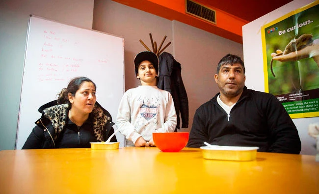 Ramin Lovimi, a refugee from Iran, his wife Shahla Lovimi and their daughter Asma Lovimi are pictured during an interview with AFP at a migrant center in Belgrade on March 14, 2018. (AFP)