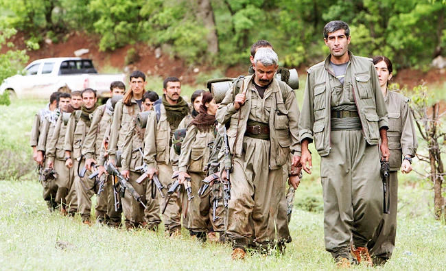 In this May 14, 2013 file photo, a group of armed Kurdish fighters from the Kurdistan Workers Party (PKK) enter northern Iraq in the Heror area, northeast of Dahuk, 260 miles northwest of Baghdad, Iraq. (AP)