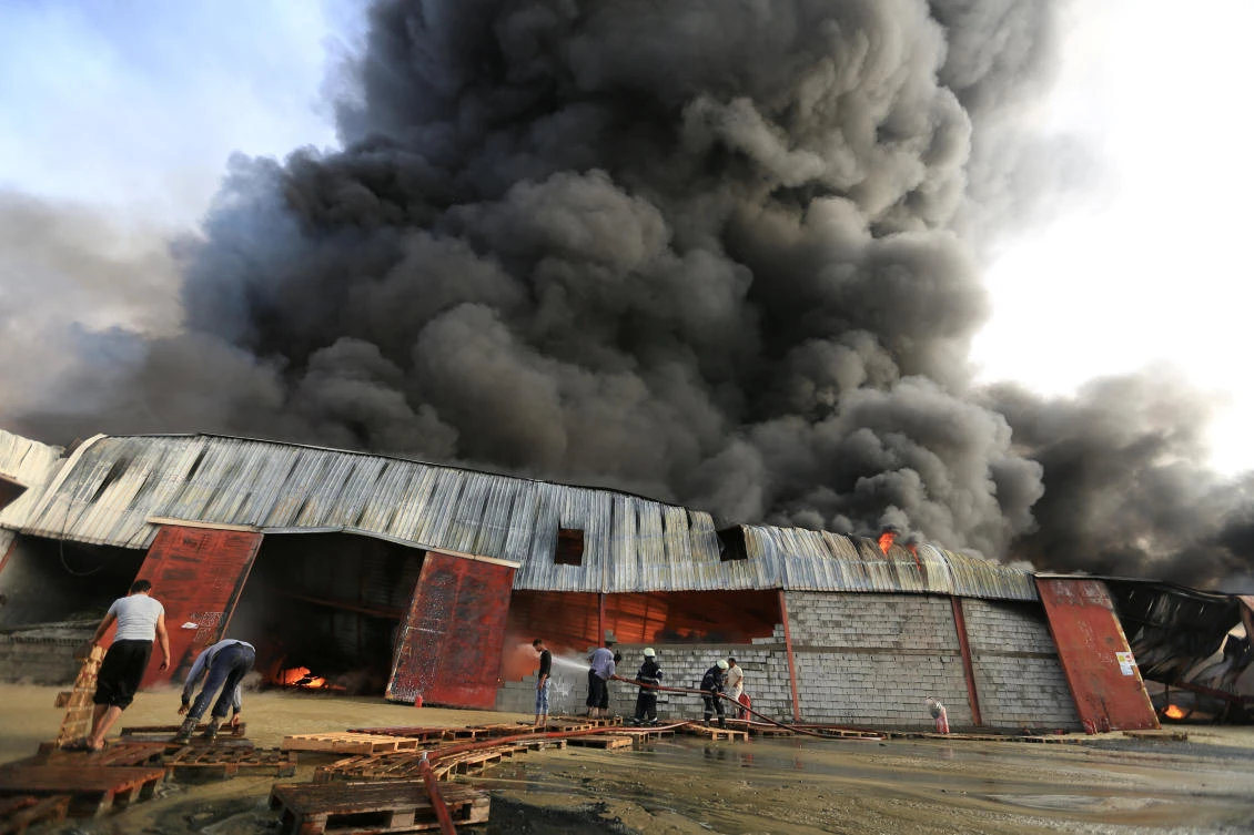 Firefighters try to extinguish a fire engulfing warehouse of the World Food Programme in Hodeida, Yemen Mar. 31, 2018. (Reuters)