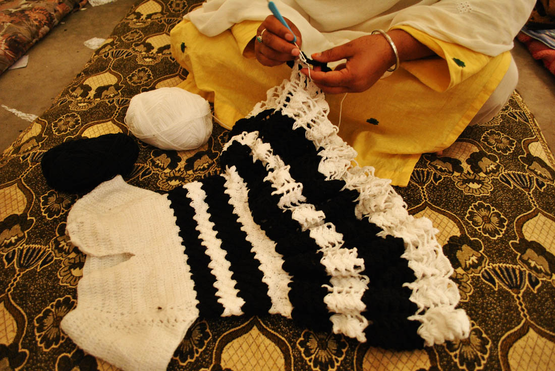 One old prisoner is knitting this small woolen shirt for babies. (AN photo by Saba Rehman)