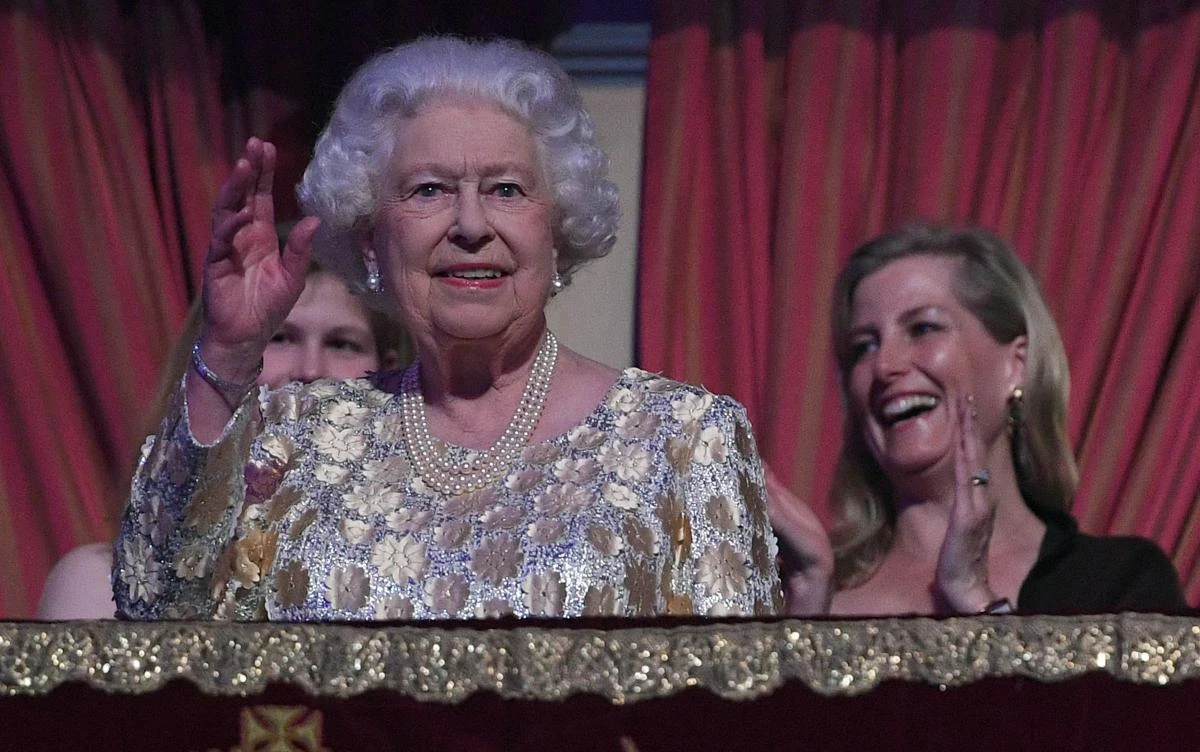Britain's Queen Elizabeth II waves to guests as she takes her seat ni the Royal box during The Queen's Birthday Party concert on the occassion of Her Majesty's 92nd birthday at the Royal Albert Hall in London on April 21, 2018. / AFP / POOL / Andrew Parsons