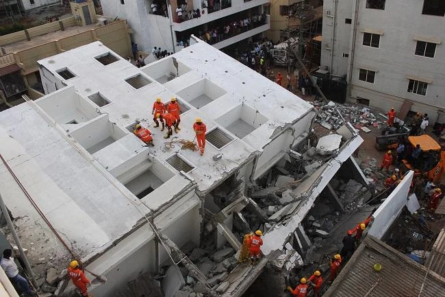 Rescue workers of the fire department and the National Disaster and Relief Force (NDRF) work at the site where a five-storey under construction building collapsed in Bangalore on February 15, 2018. (File Photo: AFP)