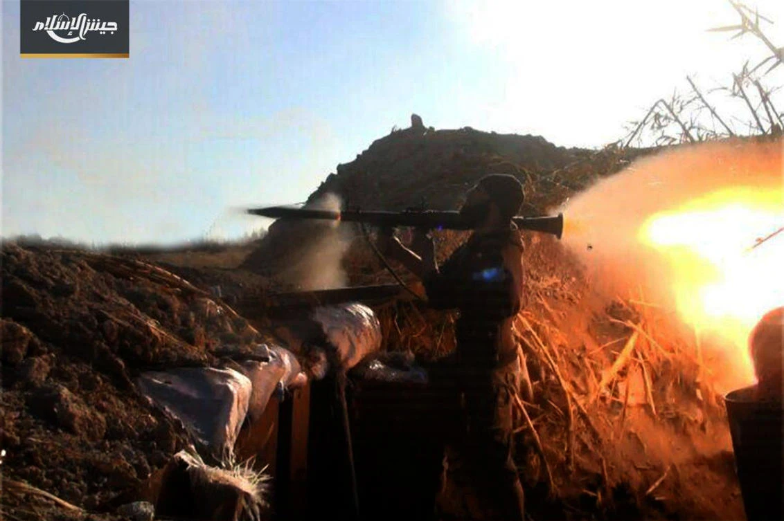 This photo provided Feb. 1, 2018, by the Syrian rebel group Army of Islam, shows a fighter with the Army of Islam rebel group, firing a weapon during clashes with government forces in Housh al-Dhawahira in the eastern Ghouta region near Damascus, Syria. (AP)