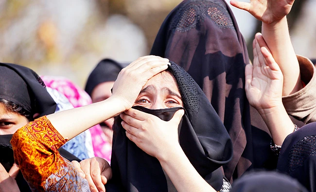 Women wail as they watch the body of Zubair Ahmed Turay being carried away during his funeral procession in south Kashmir's Shopian district on Sunday. (REUTERS)