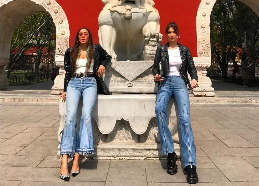 Bella Hadid (right) poses in Shanghai. (@bellahadid)