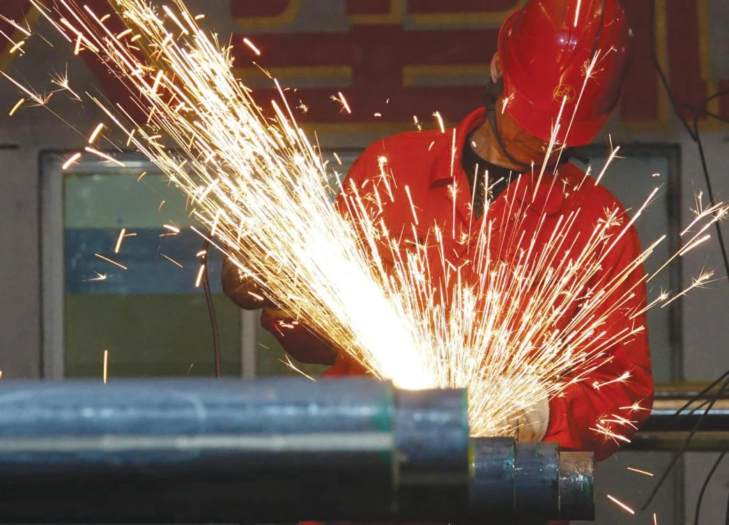 STRATEGIC TARGET: A worker polishes steel pipes at a Dongbei Special Steel Group factory in Dalian, China. (Reuters)