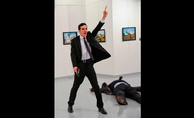 In this Dec. 19, 2016 file photo, an unnamed gunman shouts after shooting the Russian Ambassador to Turkey, Andrei Karlov, at a photo gallery in Ankara, Turkey. (AP)