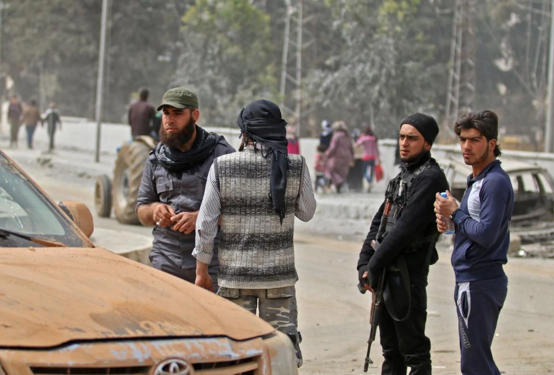 A picture taken on March 22, 2018 shows Turkish-backed Syrian fighters in a street in the northwestern Syrian city of Afrin. (AFP)