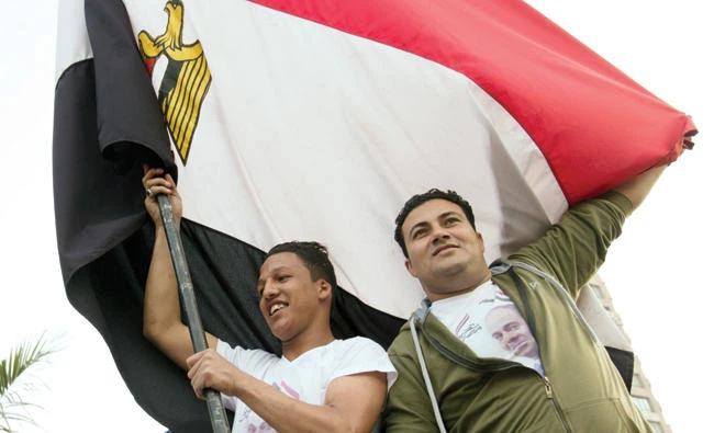 Supporters of President Abdel-Fattah El-Sissi celebrate in Mustafa Mahmoud Square after the election commission announced the presidential election results in Cairo Monday. AP