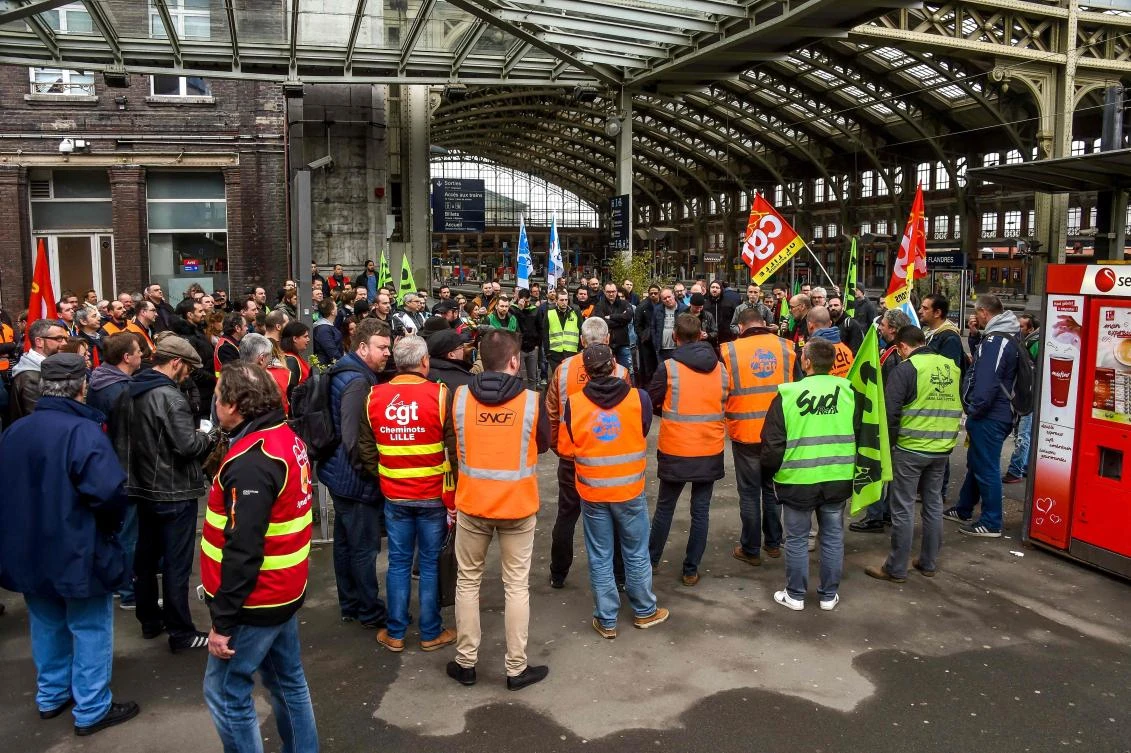 Striking workers look on as representatives speak at Lille Flandres Station in Lille on April 4, 2018, on the second day of a strike by railway workers. (AFP)