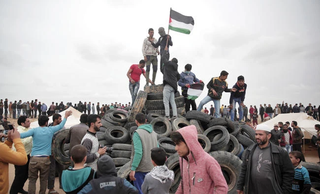 Protesters gather next
to Gaza's border with Israel, east of Khan Younis, Gaza Strip, on
Tuesday. AP
